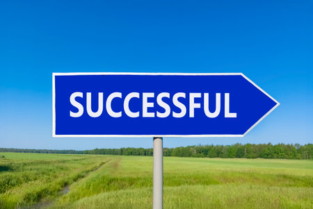 Successful symbol. Concept word Successful on beautiful blue road sign. Beautiful blue sky green...