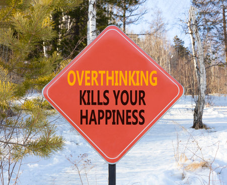 Overthinking kills your happiness symbol. Concept words Overthinking kills your happiness on red road sign. Beautiful winter background. Business overthinking kills happiness concept. Copy space.の写真素材