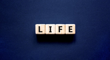 Life symbol. Concept word Life on beautiful wooden blocks. Beautiful black table black background....