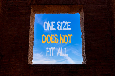 One size does not fit all symbol. Concept words One size does not fit all on beautiful window in brick wall. Beautiful blue sky background. Business one size does not fit all concept. Copy space.の写真素材