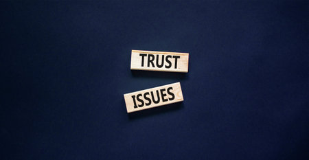 Trust issues symbol. Concept word Trust issues on beautiful wooden blocks. Beautiful black paper background. Business trust issues concept. Copy space.の写真素材