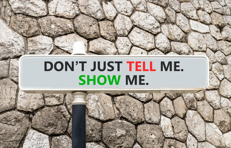 Tell or show symbol. Concept words Do not just tell me, show me on gray beautiful road sign. Beautiful stone wall background. Business tell or show concept. Copy space.の写真素材