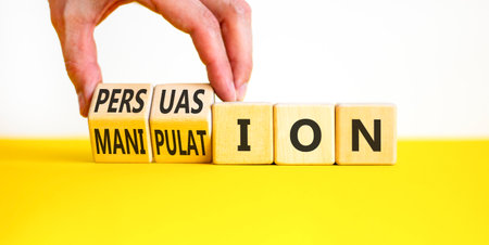 Persuasion or manipulation symbol. Concept words Persuasion and Manipulation on wooden cubes. Beautiful white background. Psychologist hand. Psychology persuasion manipulation concept. Copy space.の写真素材