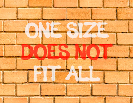 One size does not fit all symbol. Concept words One size does not fit all on beautiful brown brick wall. Beautiful brick wall background. Business one size does not fit all concept. Copy space.の写真素材