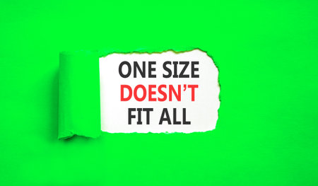 One size does not fit all symbol. Concept words One size does not fit all on beautiful white paper. Beautiful green paper background. Business one size does not fit all concept. Copy space.の写真素材