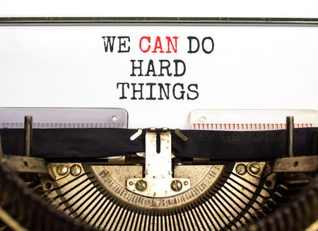 Support, help we can do hard things symbol. Concept words We can do hard things typed on beautiful old retro typewriter. Beautiful white background. Business we can do hard things concept. Copy space.の写真素材