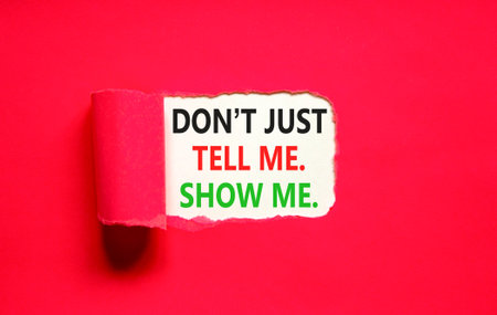 Tell or show symbol. Concept words Do not just tell me, show me on beautiful white paper. Beautiful red paper background. Business tell or show concept. Copy space.の写真素材