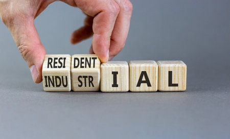 Industrial or residential symbol. Concept words Industrial or Residential on beautiful wooden blocks. Beautiful gray background. Business industrial or residential concept. Copy space.の写真素材