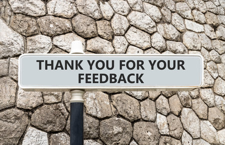 Thank you for your feedback symbol. Concept words Thank you for your feedback on gray beautiful road sign. Beautiful stone wall background. Business thank you for your feedback concept. Copy space.の写真素材