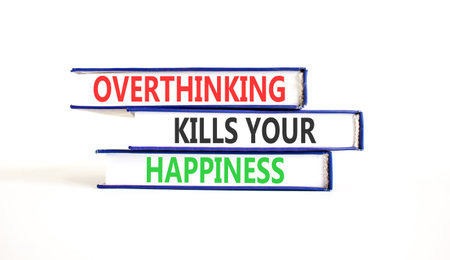 Overthinking kills your happiness symbol. Concept words Overthinking kills your happiness on books. Beautiful white paper background. Business overthinking kills happiness concept. Copy space.の写真素材