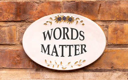 Words matter symbol. Concept word Words matter on beautiful white sign on brown old brick wall. Beautiful brown old brick wall background. Business words matter concept. Copy space.の写真素材