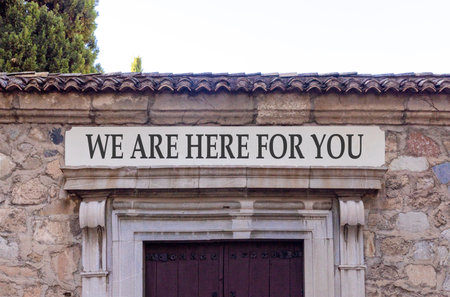 Support, help and we are here for you symbol. Concept words We are here for you on beautiful white marble sign plate. Beautiful stone wall background. Business we are here for you concept. Copy space.の写真素材