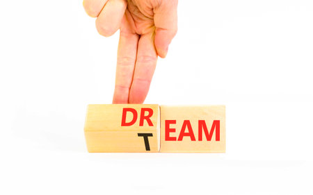 Dream team symbol. Concept words Dream team on beautiful wooden cubes. Beautiful white background. Businessman's hand. Business and dream team concept. Copy space.の写真素材