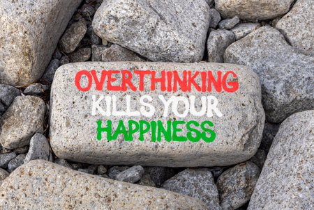 Overthinking and happiness symbol. Concept words Overthinking and happiness on gray stone. Beautiful gray stones background. Business overthinking and happiness concept. Copy space.の写真素材