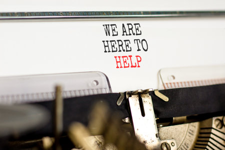 Support, help and we are here to help symbol. Concept words We are here to help typed on beautiful old retro typewriter. Beautiful white background. Business we are here to help concept. Copy space.の写真素材