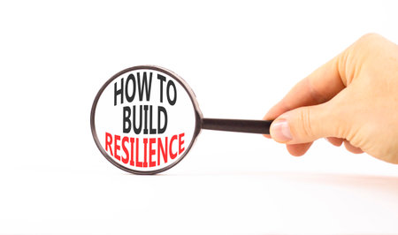 How to build resilience symbol. Concept words How to build resilience on beautiful magnifying glass. Businessman's hand. Beautiful white background. Business how to build resilience concept Copy spaceの写真素材
