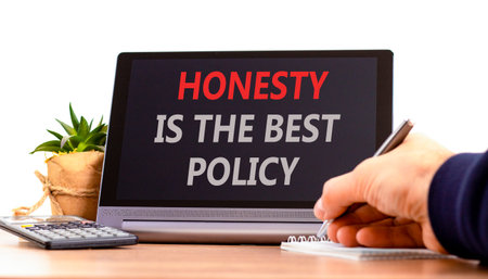Honesty is the best political symbol. Concept words Honesty is the best policy on black tablet. Beautiful white background. Businessman's hand. Business honesty is the best policy concept. Copy space.の写真素材
