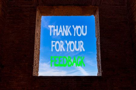 Thank you for your feedback symbol. Concept words Thank you for your feedback on window in ancient brick wall. Beautiful blue sky background. Business thank you for your feedback concept. Copy space.の写真素材