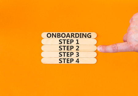 Time to step 2 onboarding symbol. Concept words Onboarding step 2 on beautiful wooden block. Businessman's hand. Beautiful orange background. Business success step 2 onboarding concept. Copy space.の写真素材