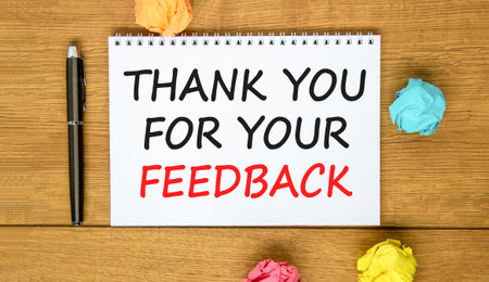 Thank you for your feedback symbol. Concept words Thank you for your feedback on beautiful white note. Beautiful wooden background. Black pen. Business thank you for your feedback concept. Copy space.の写真素材