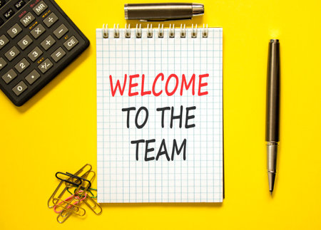 Support, help welcome to the team symbol. Concept words Welcome to the team on beautiful white note. Beautiful yellow background. Black pen. Business welcome to the team concept. Copy space.の写真素材