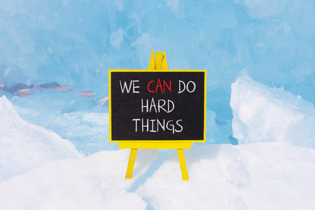 Support, help we can do hard things symbol. Concept words We can do hard things on beautiful blackboard. Beautiful blue Baikal ice background. Business we can do hard things concept. Copy space.の写真素材