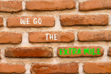 Support, help we go the extra mile symbol. Concept words We go the extra mile on beautiful brick...