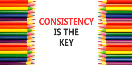 Consistency is the key symbol. Concept words Consistency is the key on beautiful white paper. Beautiful white background. Colored pencils. Business consistency is the key concept. Copy space.の写真素材