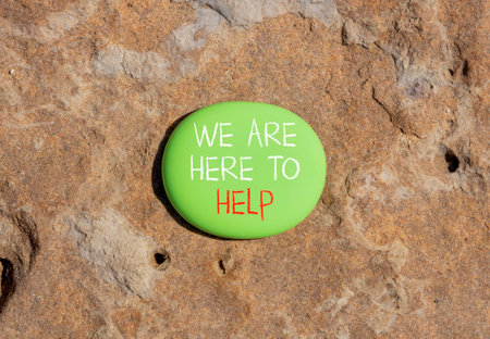 Support, help and we are here to help symbol. Concept words We are here to help on beautiful green stone. Beautiful brown stone background. Business we are here to help concept. Copy space.の写真素材