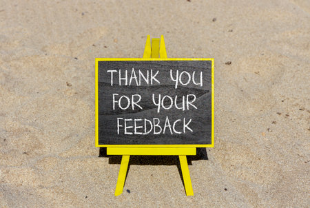 Thank you for your feedback symbol. Concept words Thank you for your feedback on beautiful blackboard. Beautiful sand beach background. Business thank you for your feedback concept. Copy space.の写真素材