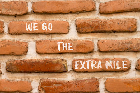 Support, help we go the extra mile symbol. Concept words We go the extra mile on beautiful brick...