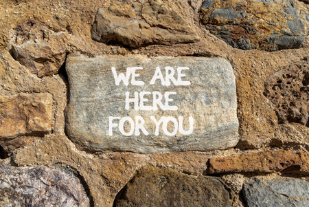 Support, help and we are here for you symbol. Concept words We are here for you on beautiful gray stone. Beautiful stone wall background. Business we are here for you concept. Copy space.の写真素材