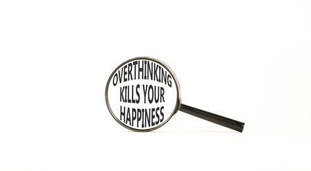 Overthinking kills your happiness symbol. Concept words Overthinking kills your happiness on magnifying glass. Beautiful white background. Business overthinking kills happiness concept. Copy space.の写真素材