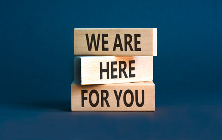 Support, help and we are here for you symbol. Concept words We are here for you on wooden blocks....