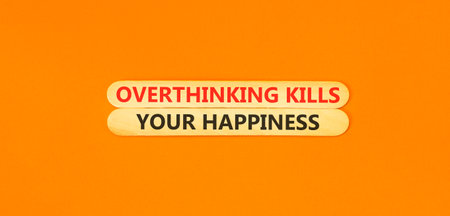Overthinking kills your happiness symbol. Concept words Overthinking kills your happiness on wooden sticks. Beautiful orange background. Business overthinking kills happiness concept. Copy space.の写真素材