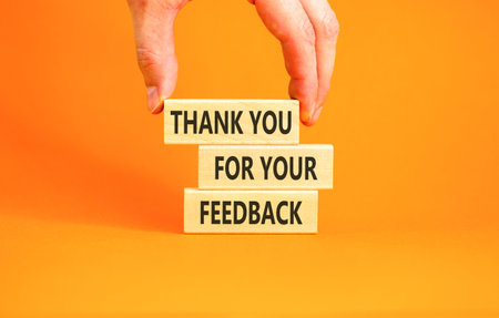 Thank you for your feedback symbol. Concept words Thank you for your feedback on beautiful wooden blocks. Beautiful orange background. Business thank you for your feedback concept. Copy space.の写真素材