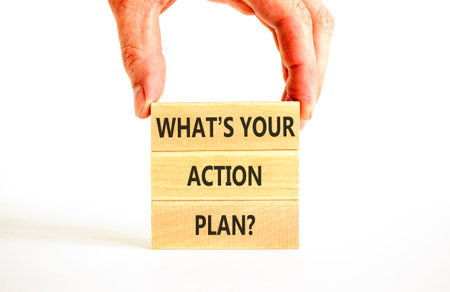 What is your action plan symbol. Concept words What is your action plan on beautiful blocks. Beautiful white background. Businessman's hand. Business what is your action plan concept. Copy space.の写真素材