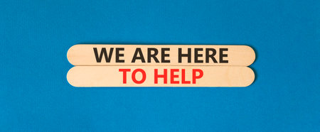 Support, help and we are here to help symbol. Concept words We are here to help on beautiful wooden...