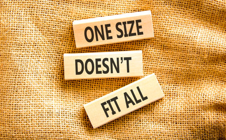 One size does not fit all symbol. Concept words One size does not fit all on beautiful wooden blocks. Beautiful canvas background. Business one size does not fit all concept. Copy space.の写真素材