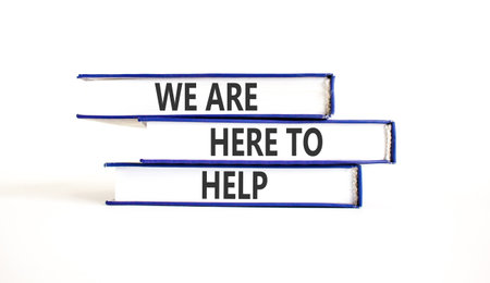 Support, help and we are here to help symbol. Concept words We are here to help on beautiful books. Beautiful white paper background. Business we are here to help concept. Copy space.の写真素材