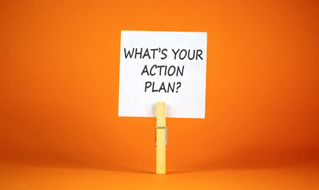 What is your action plan symbol. Concept words What is your action plan on beautiful white paper on clothespin. Beautiful orange background. Business what is your action plan concept. Copy space.の写真素材