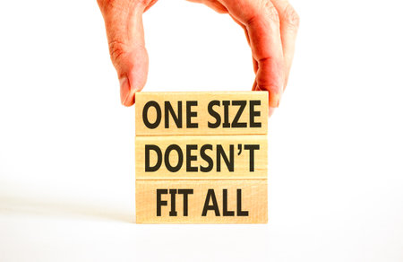 One size does not fit all symbol. Concept words One size does not fit all on beautiful wooden blocks. Beautiful white background. Business one size does not fit all concept. Copy space.の写真素材