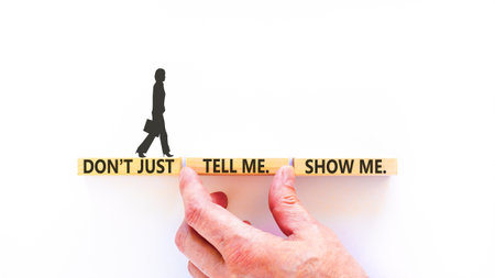 Tell or show symbol. Concept words Do not just tell me, show me on beautiful wooden blocks. Beautiful white background. Businesswoman's icon. Business tell or show concept. Copy space.の写真素材