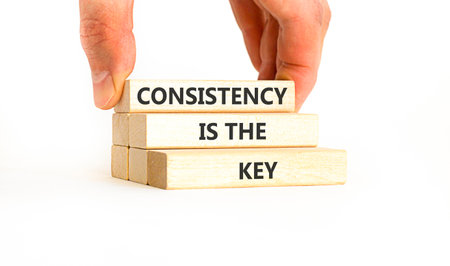 Consistency is the key symbol. Concept words Consistency is the key on beautiful wooden blocks....