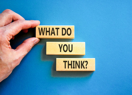 Support, help what do you think symbol. Concept words What do you think on beautiful wooden blocks. Beautiful blue background. Businessman's hand. Business what do you think concept. Copy space.の写真素材