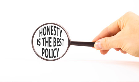 Concept words Honesty is the best policy on beautiful magnifying glass. Beautiful white background....