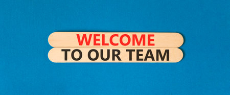 Support, help welcome to our team symbol. Concept words Welcome to our team on beautiful wooden sticks. Beautiful blue background. Business welcome to our team concept. Copy space.の写真素材
