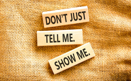 Tell or show symbol. Concept words Do not just tell me, show me on beautiful wooden blocks....
