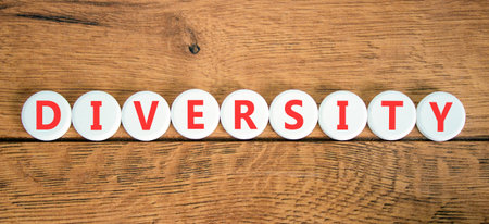 Diversity symbol. Concept words Diversity on beautiful white circles. Beautiful wooden background. Business support diversity DEI concept. Copy space.の写真素材