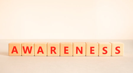 Awareness symbol. Concept word awareness on beautiful wooden blocks. Beautiful white and gray background. Business education awareness concept. Copy space.の写真素材